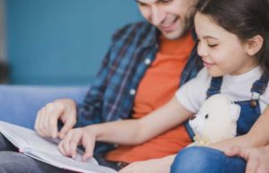 Child reading with Dad