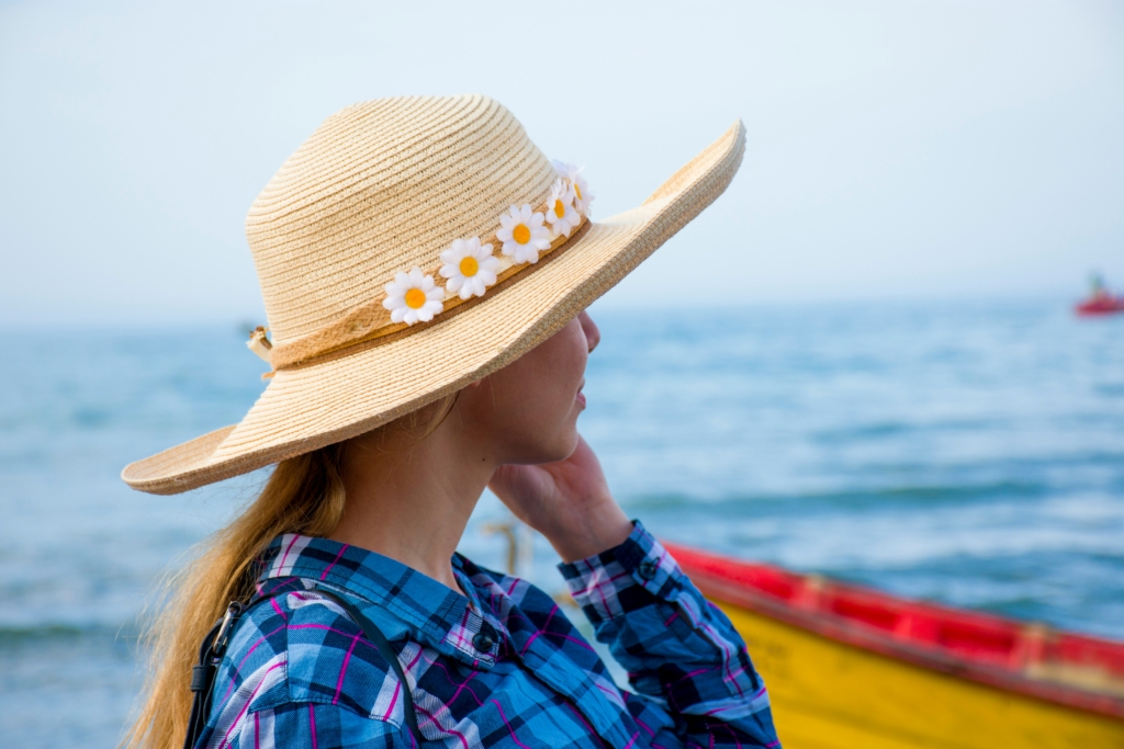 woman with sun hat on How to Dress for Outdoor Events this Spring