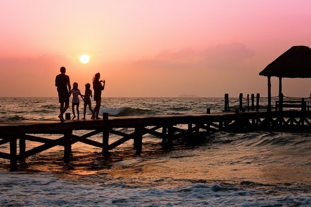 family weekend getaway ideas family at the beach by the water on a pier