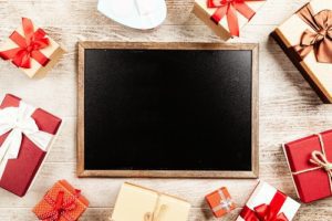 Empty chalkboard surrounded by presents - shopping