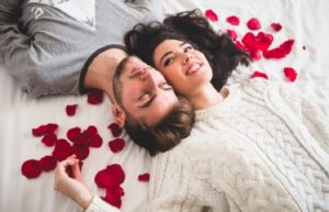 According to a study that we recently checked out, one of the keys to a healthy and happy marriage is that couples go on dates no less than once a month. Couples who do are 14 percent less likely to end up divorced. But what happens when your schedules are super-hectic, money is tight and/or you can’t seem to find a babysitter? Does that mean that you should nix dating plans altogether? Or, say that you’re not married but the relationship is headed towards getting serious. Thing is, the soon-to-be love of your life is extremely introverted or simply isn’t big on going out. What then? We know that there are more than a few people who happen to fall into these categories and we’ve got the perfect solution—have an at-home date instead! They’re fun, affordable and, with the right amount of pre-planning, they can be super-romantic too. Are you ready to be inspired with some at-home date ideas? Have an indoor picnic. One of our favorite at-home date options is having a picnic indoors. You can order some of your favorite takeout, put on some soft music, pull out a blanket and enjoy a great meal. You can even take things up a notch by building a tent for the two of you to hideout in. Replay your first movie date. If you’ve been together for a while, something that can bring the old magic back is taking a stroll down memory lane. One idea is to watch the first movie you ever saw together. Don’t forget to have some popcorn, dark chocolate candy and homemade soda on hand. For the soda, all you need is some sparkling water and juice and you’re all set! Cook each other’s favorite meals. When you’re alone in the kitchen, cooking can sometimes feel like work. But when your sweetheart is standing beside you helping, it can give you both some of the quality time that your relationship needs. Either each of you can make one another’s favorite dish or you can agree to make something together that neither of you have ever had before (firsts in relationships are always something that adds spice to it!). Hire an indoor chef. If it’s a special occasion but you’d still prefer to stay close to home, instead of cooking, hire an indoor chef. Most are pretty affordable and you’ll be able to get the five-star treatment from the comfort and convenience of your own home. Play some board games. If the kids are away or asleep, pull out a few board games. We’re not talking about Monopoly or Trouble. What we have in mind are the kind of games that tap into your more intimate or even kinkier side. Some fan favorites include [easyazon_link identifier="B0041NK5PM" locale="US" tag="twkmobile-20"]The Discovery Game[/easyazon_link], [easyazon_link identifier="B07BSGVR6X" locale="US" tag="twkmobile-20"]Bedroom Battle[/easyazon_link], [easyazon_link identifier="B0018OUWK0" locale="US" tag="twkmobile-20"]The Kama Sutra[/easyazon_link], [easyazon_link identifier="B078RDNFSC" locale="US" tag="twkmobile-20"]Our Moments[/easyazon_link] and [easyazon_link identifier="B07FC474S6" locale="US" tag="twkmobile-20"]Better Now Than Later[/easyazon_link]. Turn things up a notch by playing the games in some sexy sleepwear or…even nude. Have a romantic couples massage. There are literally dozens of health benefits that come from getting massages on a regular basis. They relieve stress and anxiety, reduce headaches, increase blood circulation and flexibility, improve one’s quality of sleep—the list really does go on and on and on. Although it’s a good idea to get one from a professional every once in a while, it can be uber-romantic to get one from your partner and give one to them in return. All you need is a little sweet [easyazon_link identifier="B0019LVFSU" locale="US" tag="twkmobile-20"]almond oil[/easyazon_link] and [easyazon_link identifier="B01GOLFBIY" locale="US" tag="twkmobile-20"]jasmine essential oil[/easyazon_link] warmed up to make a [easyazon_link identifier="B019FW8PA0" locale="US" tag="twkmobile-20"]sensual massage oil[/easyazon_link]. Then you can click here for tips on how to give each other a massage that is truly unforgettable. DIY a bottle of wine. If you’d love nothing more than to light some scented (soy) candles, break open a bottle of wine and just chill, surprise your partner by handing them a glass of wine that was literally customized just for them. Contrary to popular belief, making wine (or even champagne) is not super difficult. Click here for an easy wine recipe and here for a fun champagne one. “Quiz” each other. One of the main causes of divorce is a lack of clear and honest communication. Get to know your spouse/partner even better by asking them some deep questions. Keep it from feeling too much like an interrogation by creating your own form of “strip questionnaire” or rewarding each other with some [easyazon_link identifier="1601060203" locale="US" tag="twkmobile-20"]sexy coupons[/easyazon_link] or “[easyazon_link identifier="030745052X" locale="US" tag="twkmobile-20"]sex checks[/easyazon_link]” every time you tap into your vulnerabilities. Do some body painting. Break out the inner artist in the both of you by doing a little painting. Make it erotic by using each other as canvases. You can either [easyazon_link identifier="B01K8UGGVI" locale="US" tag="twkmobile-20"]purchase some body paint[/easyazon_link] that glows in the dark (very cool) or you can make some of your own that’s, umm, edible and chocolate flavored. Go glamping (in your backyard). Glamping is something that’s become all the rage for the past several years. If you can’t afford to take a trip in order to do it, do some glamorous camping in your own backyard with the help of a bonfire, some s’mores, a [easyazon_link identifier="B071V3XH1Z" locale="US" tag="twkmobile-20"]two-room solar-heated camping tent[/easyazon_link] and…whatever else you think would make a night underneath the stars extra awesome. Have (lots and lots of) fun! And don't forget to fit a date night into your busy schedule at least once a month!