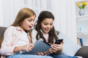 kids using their phones or electronic devices