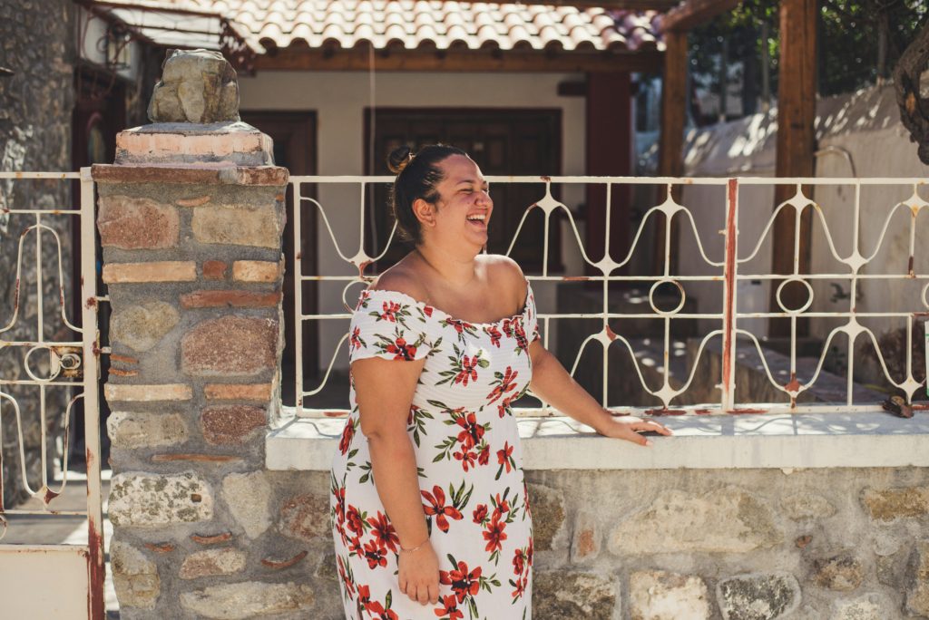 woman in dress smiling what to wear to a summer wedding