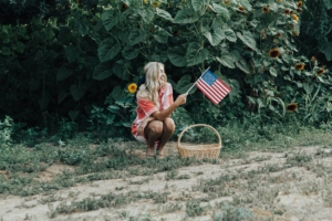 memorial day weekend outfit ideas woman with american flag america 4th of july