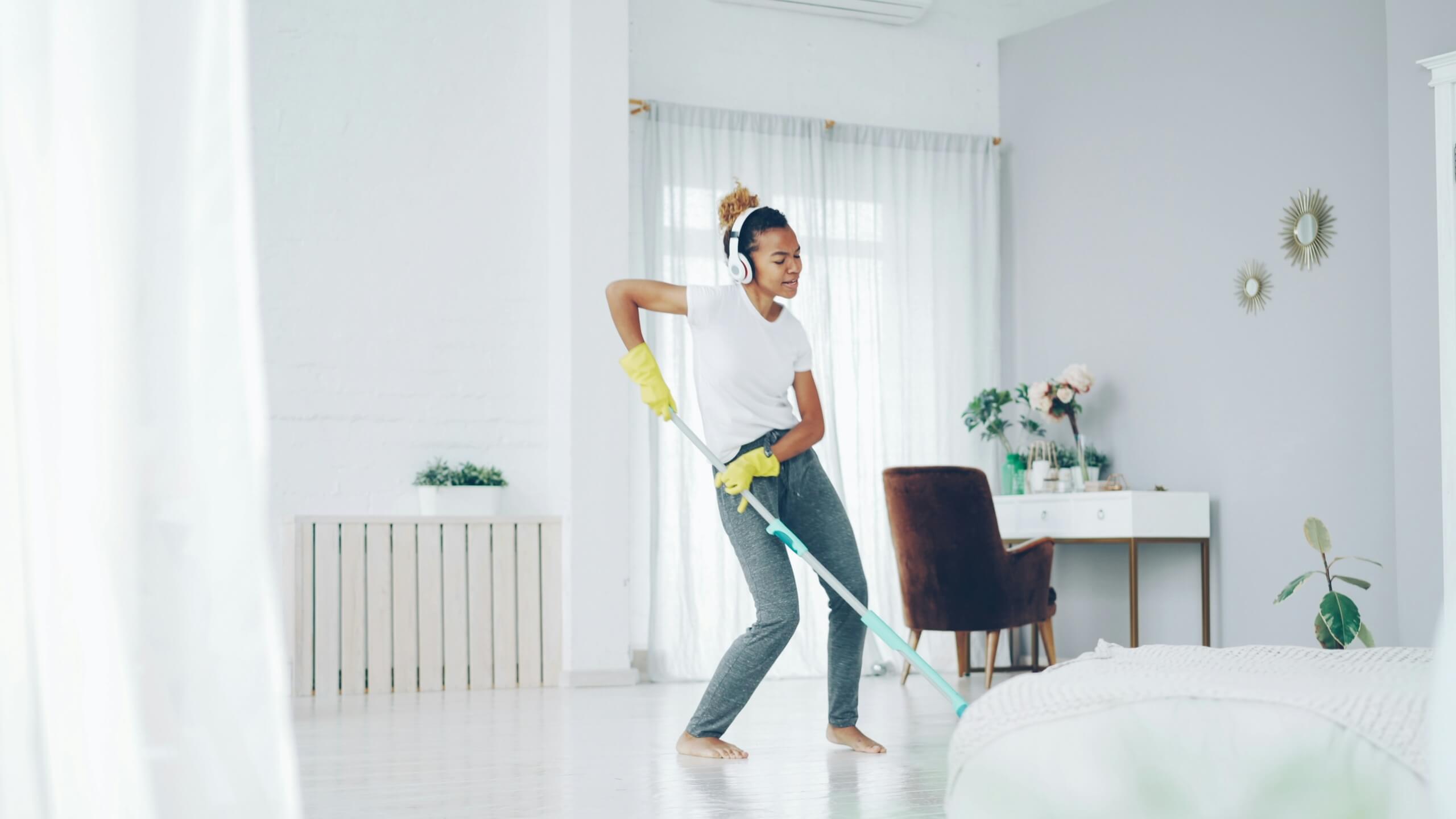 woman dancing while cleaning spring cleaning motivation hacks