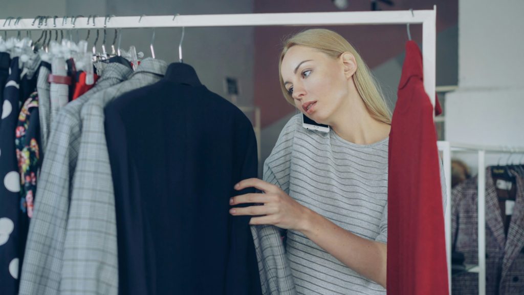 woman looking through closet 2026 spring capsule wardrobe