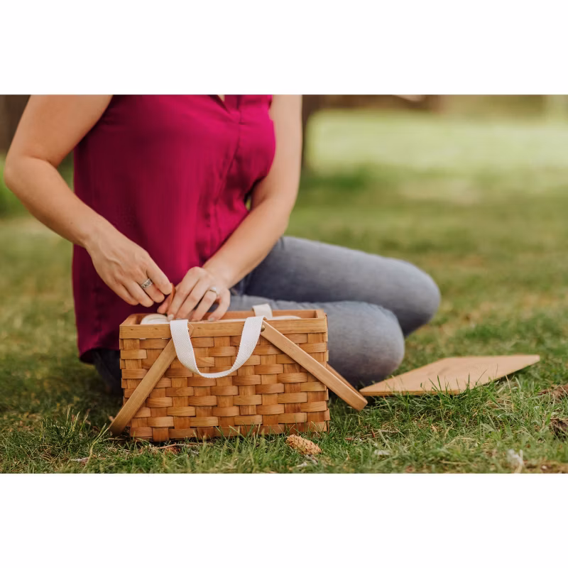 Person unpacking a picnic basket.