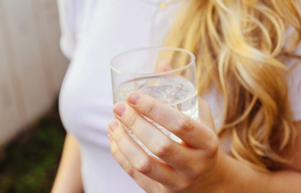 woman drinking water Tips for Sleep Deprived Moms