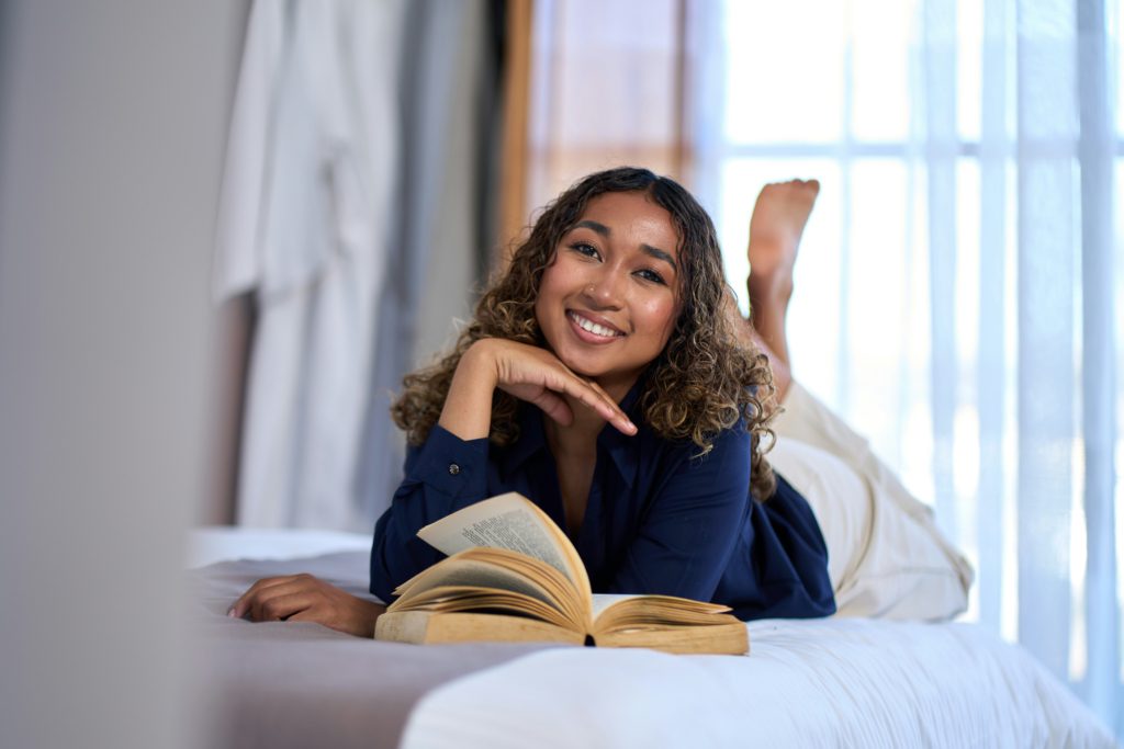 woman reading a book and smiling simple new hobbies for women