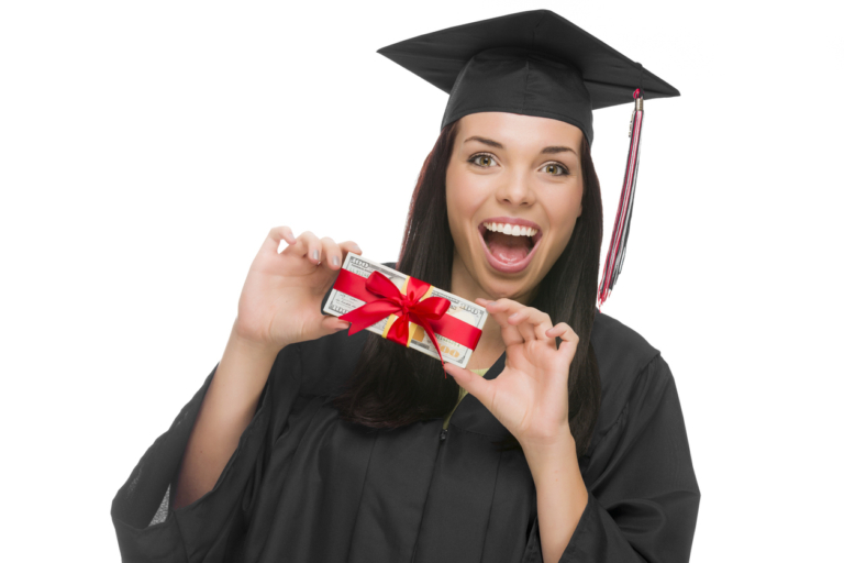 Happy Female Graduate in Cap and Gown Holding Stack of Gift Wrapped Hundred Dollar Bills Isolated on a White Background.