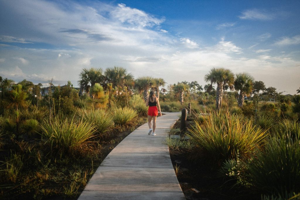 woman walking on a boardwalk Walking Outfits for Spring