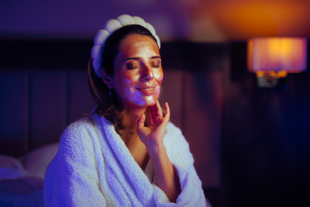 Beautiful lady trying different cosmetic procedures at home skin care face mask cozy spa night How to Have the Perfect Spa Night at Home