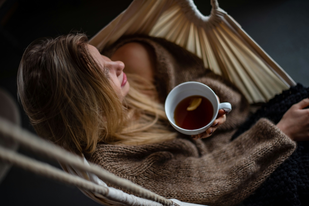 woman drinking tea cozy How to Have the Perfect Spa Night at Home