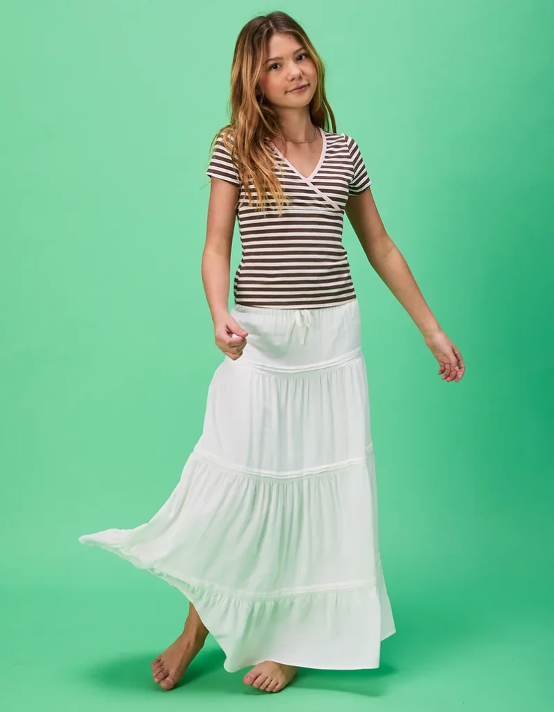 Girl in striped shirt and skirt back to school outfits for girls