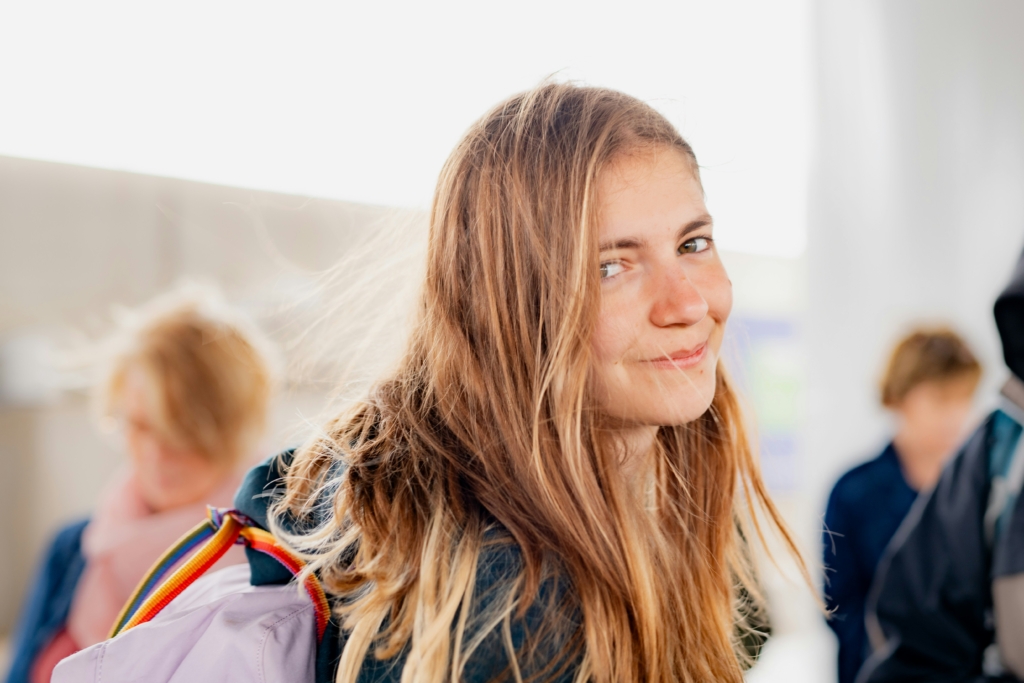 Smiling girl with long hair back to school outfits for teen girls