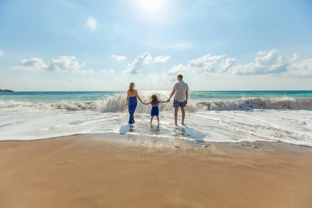 family at the beach traveling trip beach day sunshine family weekend getaway ideas