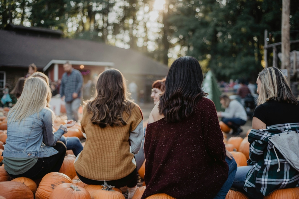 woman sitting at a pumpkin patch pumpkin patch outfits