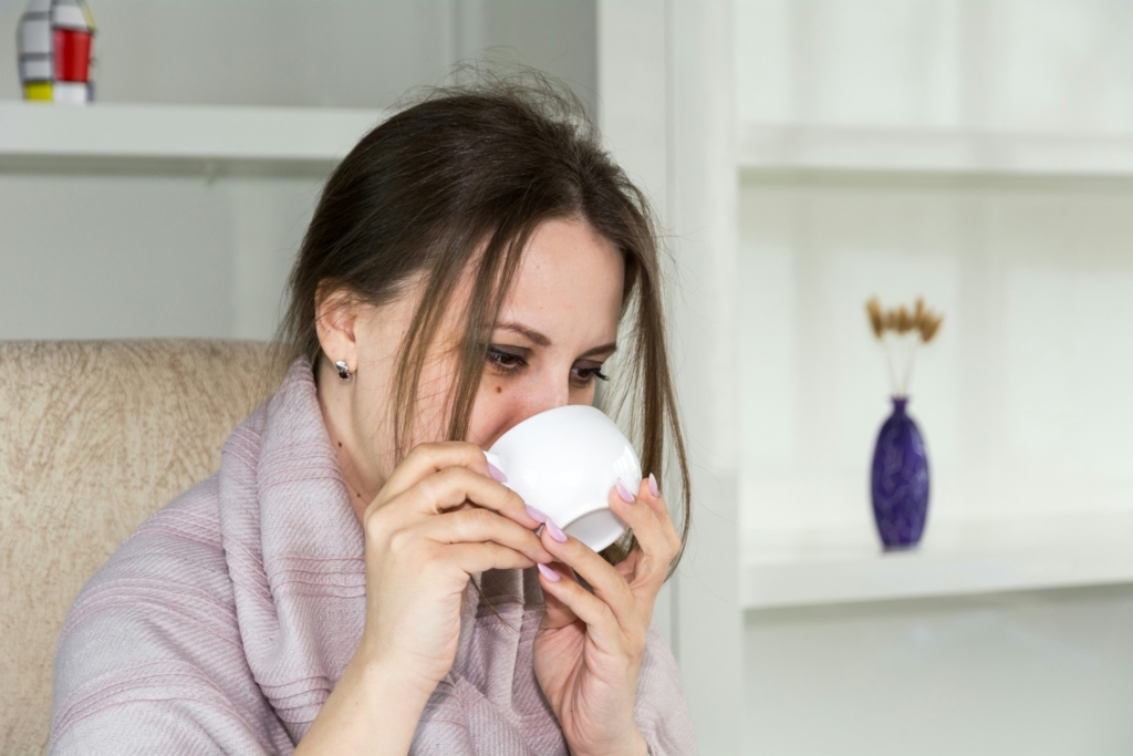 woman drinking coffee with the flu best cold and flu medicine best cold and flu remedies