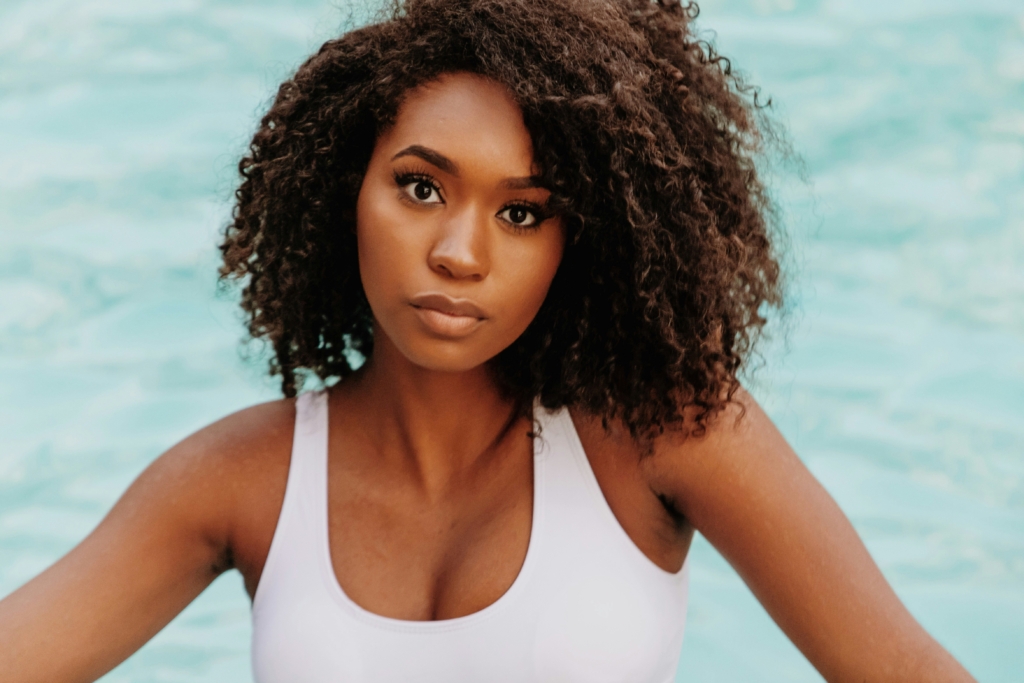 woman with beautiful curly hair afro personalized hair care products
