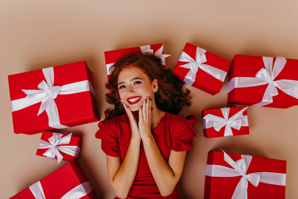 woman with presents around her for christmas best holiday gifts for women