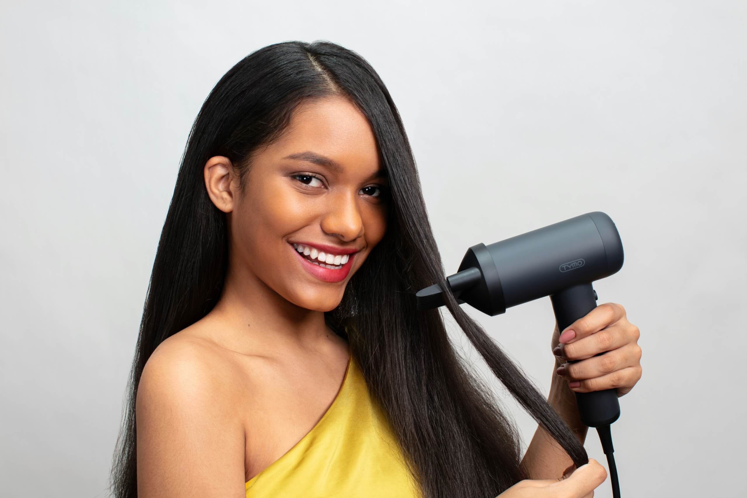 Person styling hair with hairdryerair