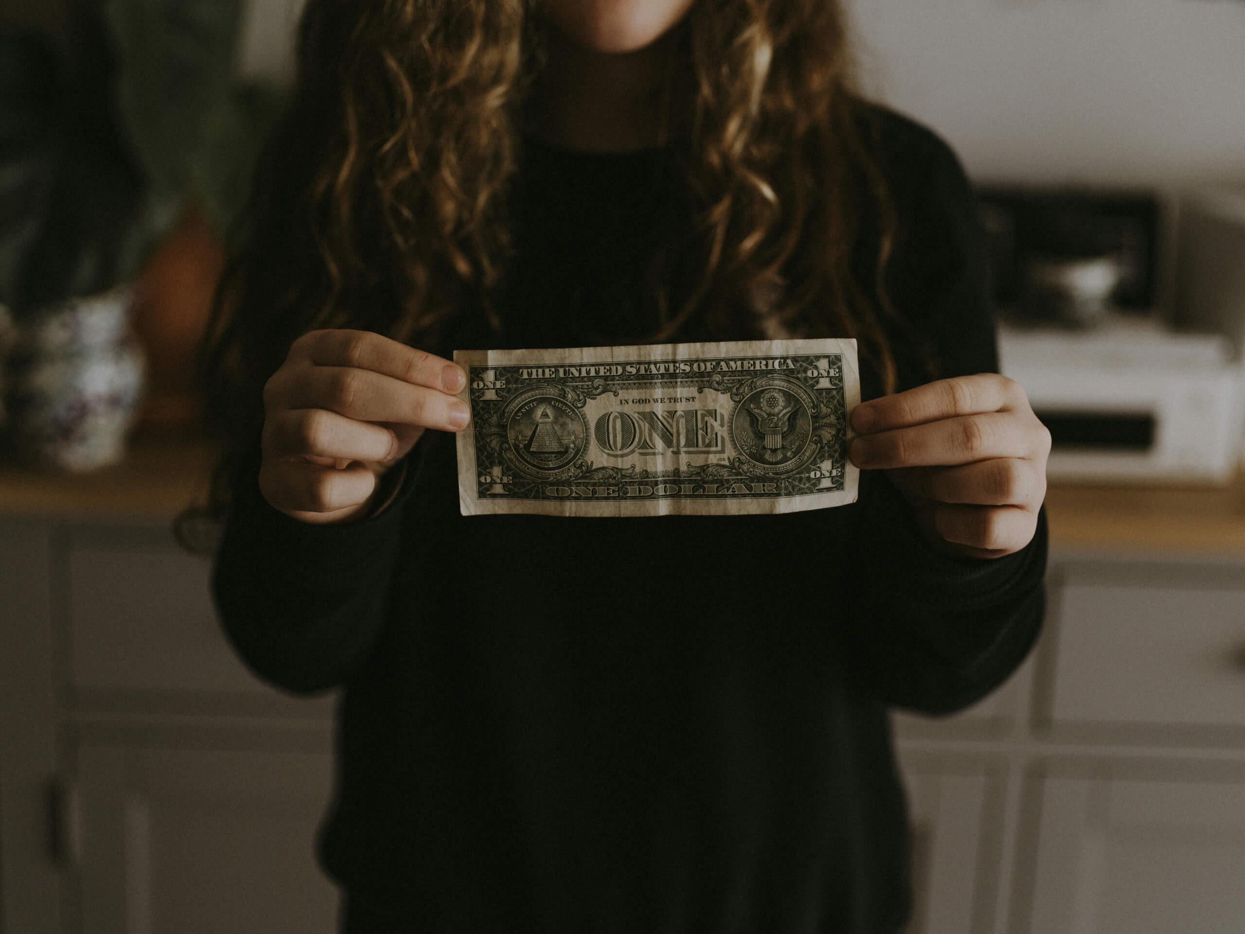 teen holding cash