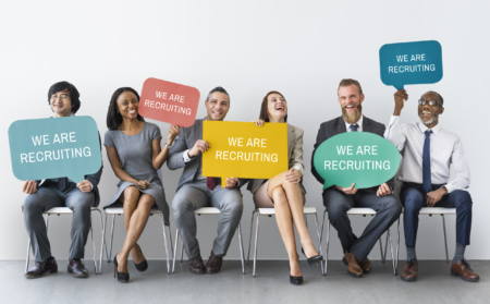 People holding "We Are Recruiting" Signs - Make a Job Posting