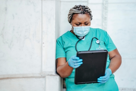 Focused woman with documents in hospital - nurse recruiter