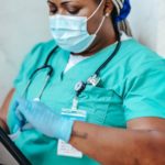Crop nurse in mask and gloves with papers - nurse recruiter