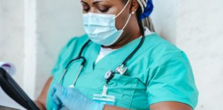 Crop nurse in mask and gloves with papers - nurse recruiter