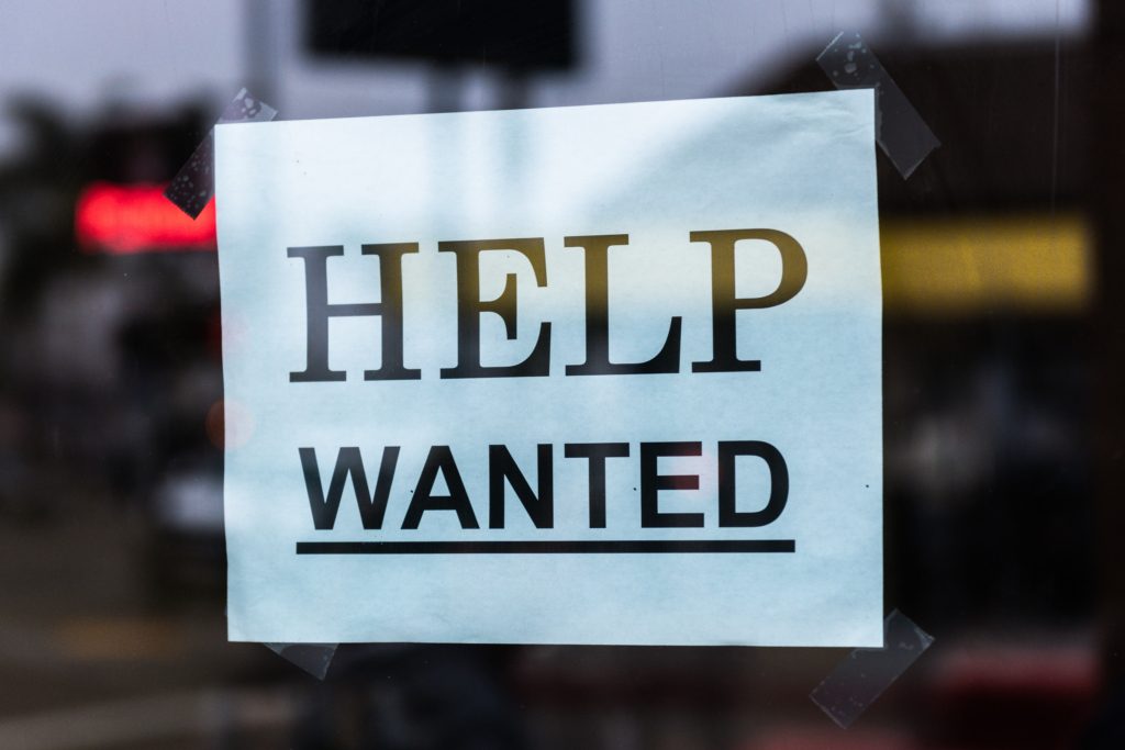 Help wanted sign on glass - Job seekers near me