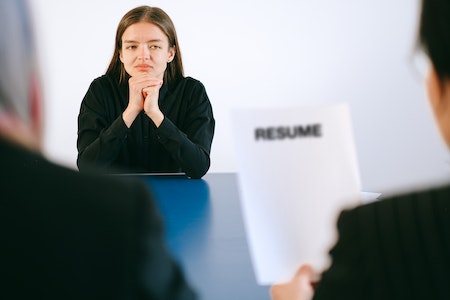 Woman in Black Long Sleeve Shirt Sitting Having Interview - free resume search for employers