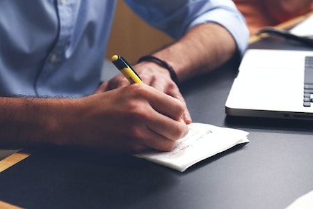 erson Writing on Paper Using Yellow and Black Pen - career change at 30