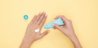 Person Pouring Plastic Tube Bottle - best hand cream for dry hands