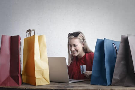 Happy woman shopping online at home