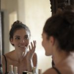 Reflection Photo of Woman Smiling - best facial cleanser for dry skin