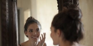 Reflection Photo of Woman Smiling - best facial cleanser for dry skin