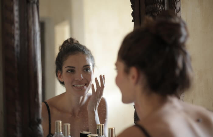 Reflection Photo of Woman Smiling - best facial cleanser for dry skin