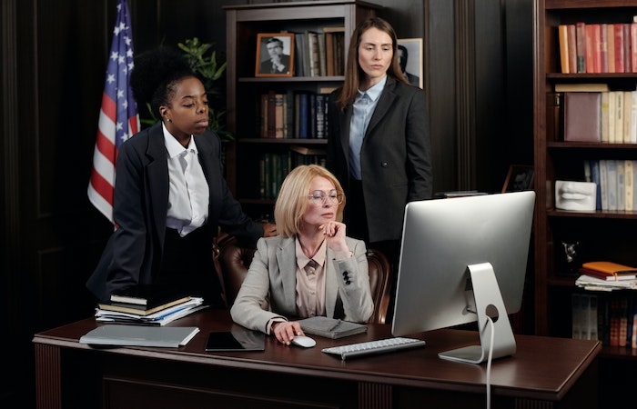 Businesswomen in an Office Looking at a Computer - remote paralegal jobs