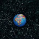 Earth globe placed on dark grass - eco friendly gift ideas