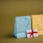 Assorted gift bags with cords on brown background