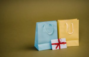 Assorted gift bags with cords on brown background