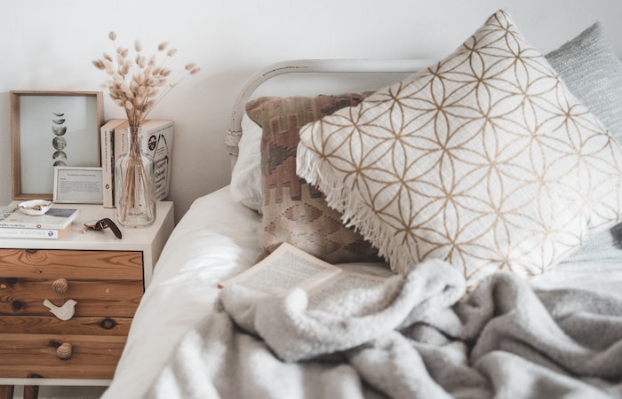 White and Brown Throw Pillow on White Bed - winter home decor