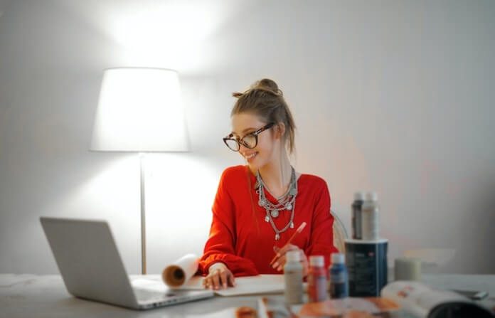 Woman in Red Long Sleeve Shirt Looking At Her LAptop - remote nonprofit jobs