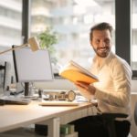 Photo of Man Holding a Book - 4 day work week jobs