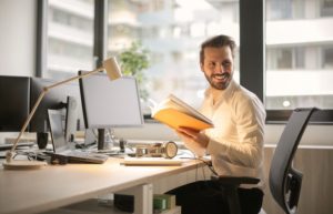 Photo of Man Holding a Book - 4 day work week jobs