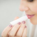 Woman Putting Lipstick - winter fresh sugar lip balm