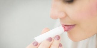 Woman Putting Lipstick - winter fresh sugar lip balm