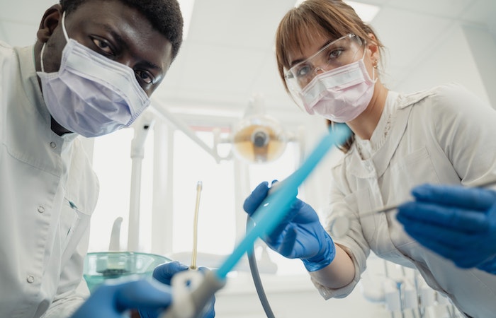 Oral Health Workers Holding Dental Tools - hire dental assistant