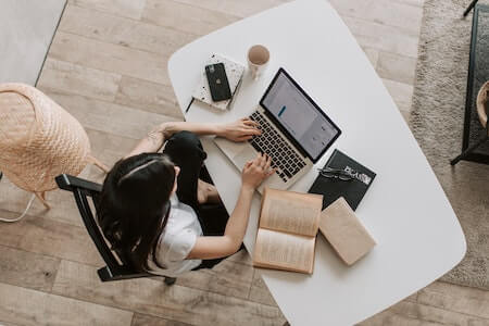 Young lady typing on keyboard of laptop in living room - Zip Recruiter jobs